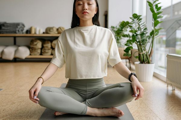 Person meditating peacefully during an evening yoga session.